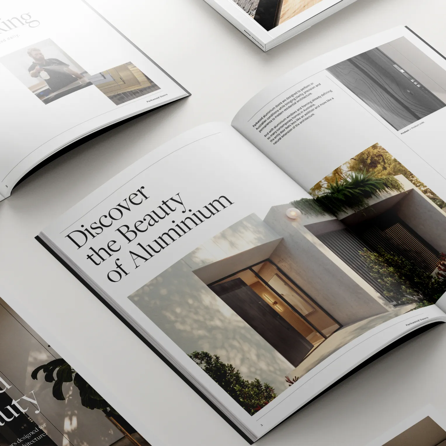 Open Parkwood brochures on a white surface, one spread headed “Discover the Beauty of Aluminium”