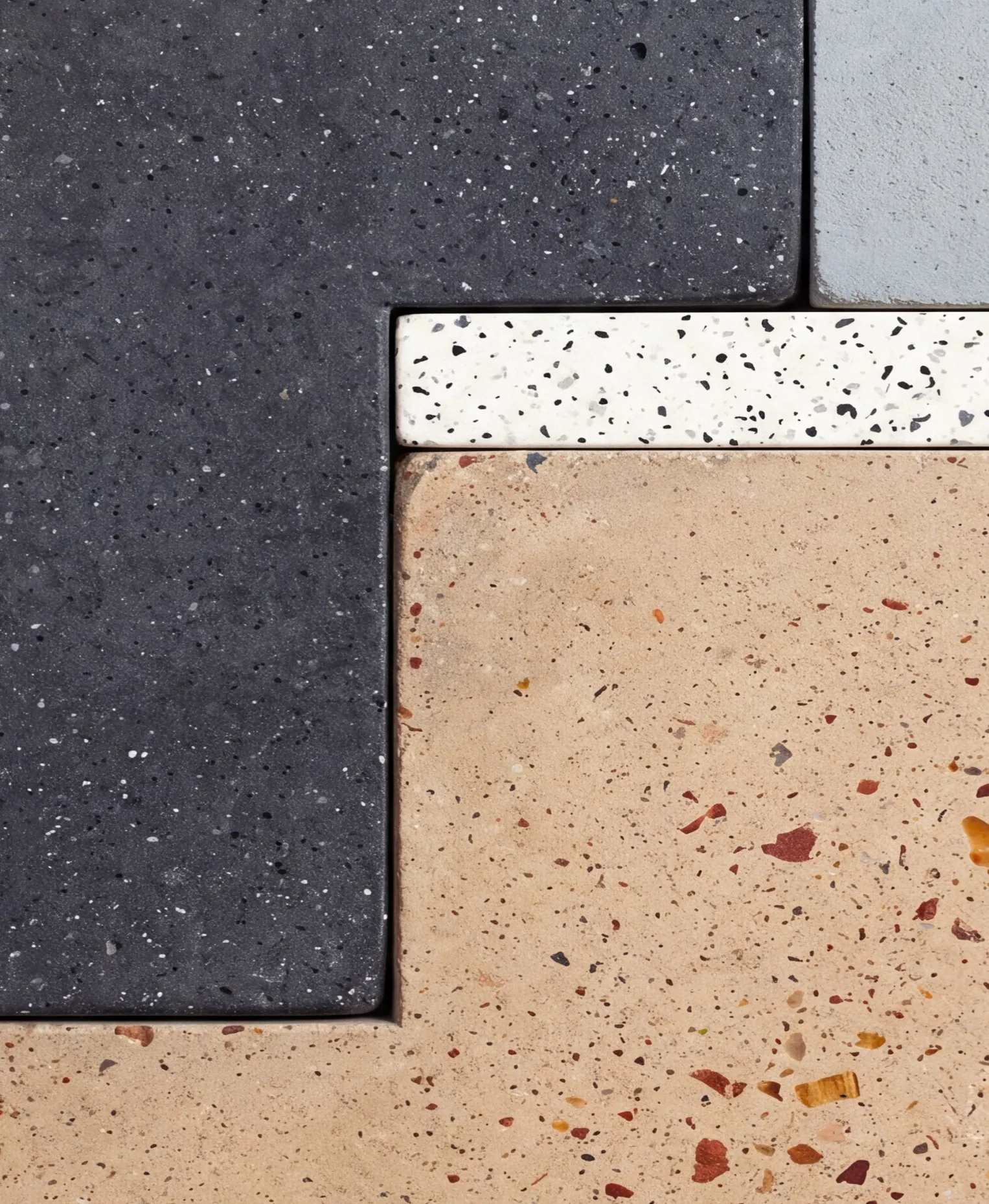 Terrazzo slabs in charcoal, white and sand fitted together like a puzzle