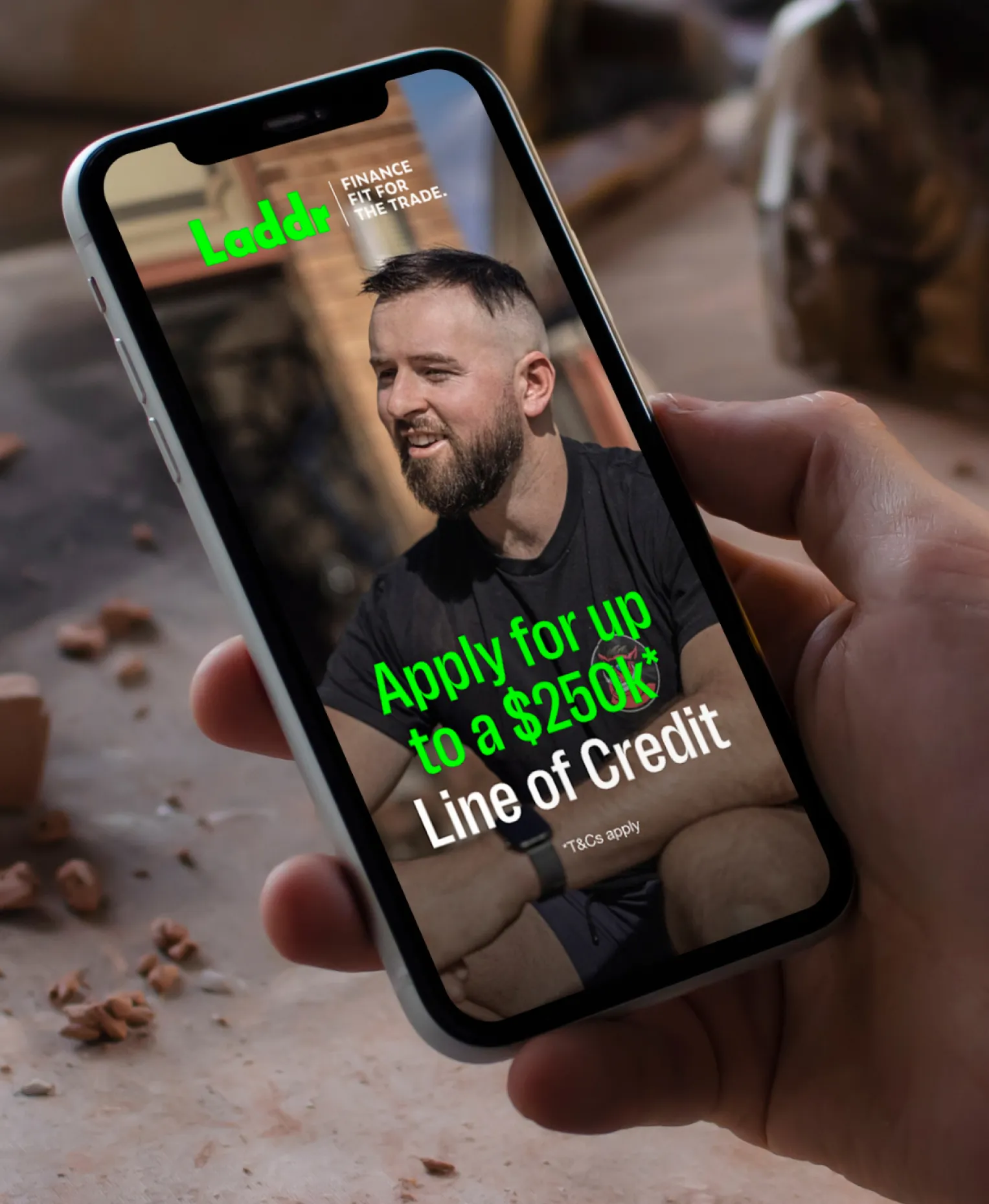 A phone showing a Laddr ad: a bearded tradie under the Laddr logo and “Finance fit for the trade.”, with “Apply for up to a $250k* Line of Credit”