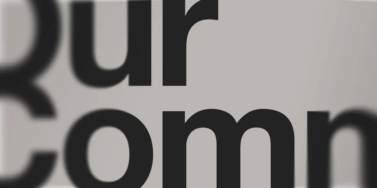“Our commitment” in large black type, cropped by the frame, beside “Written by our founders: Carlo Tarquinio & Gavin Pitcher”